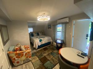 a bedroom with a bed and a table in it at Private Retreat in Lake Worth