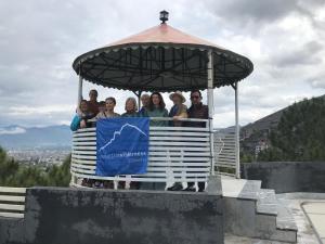 eine Gruppe von Menschen, die in einem Pavillon mit einer Flagge stehen in der Unterkunft SWAT HILL VIEW RESORT- only for families in Swat