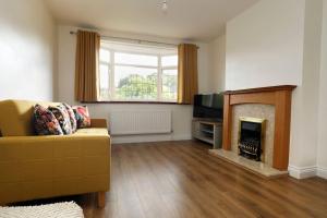 a living room with a couch and a fireplace at Beautiful Home in West Midlands 