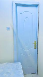 a blue door in a room with a bed at Dar Al Mansoor Vacation Homes LLC in Dubai