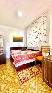 a bedroom with a bed and a table and a chair at Alyvų Vila - Palanga All House Just For You in Palanga