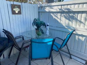 a glass table and chairs on a patio at Private Retreat in Lake Worth