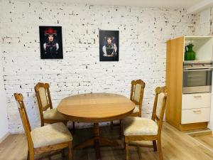 a kitchen with a wooden table and two pictures on the wall at Gemütliche Unterkunft in Baden-Baden direkt am Schwarzwald in Baden-Baden +2 photos