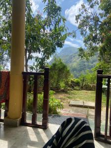 a balcony with a view of a mountain at Pasan Guest in Ella