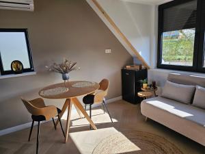 a living room with a table and a couch at Ybizee in Yerseke