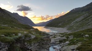 a view of a river between two mountains at Pension Central in Saas-Almagell