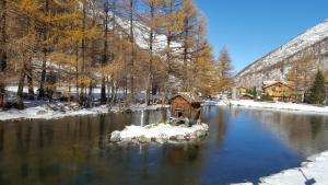 a small house in the middle of a river at Pension Central in Saas-Almagell
