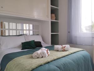 a bedroom with a bed with two stuffed animals on it at La Casa nel Parco - Stadio Olimpico, Auditorium con posto auto in Rome