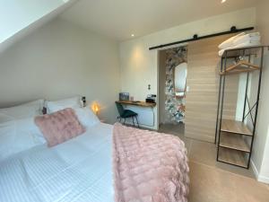 a bedroom with a large white bed and a desk at La Pause de Gabin - Terrasse - Parking in Vannes