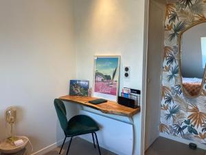 a room with a desk with a chair and a mirror at La Pause de Gabin - Terrasse - Parking in Vannes