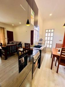 a kitchen and living room with a stove top oven at Serenity Homes Arusha in Arusha