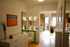a living room with a white dresser and mirrors at Cozy flat with side Baltic Sea view in Pärnu +29 photos