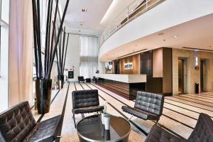 a lobby with chairs and a table in a building at Maximus Luxury in Berrini - Flat at the Radisson Hotel in São Paulo