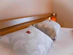 a bed with a pillow and a flower on it at Ferienwohnung Gaby Lehmann in Hornberg