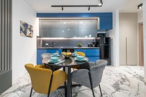 a kitchen with a table and chairs in a room at Sunset Premium Residence II & III in Dubrovnik