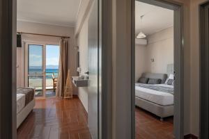 a bedroom with a bed and a view of the ocean at house giota in Sarti