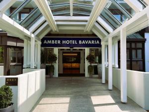 an entrance to a hotel building with a glass ceiling at AMBER HOTEL Bavaria in Bad Reichenhall
