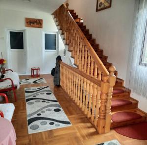 a wooden staircase in a living room at Urban Hostel in Peje