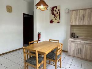 a dining room table and chairs in a kitchen at Apartment with sea view in Blue Bay, 125 m², near beach in Blue Bay
