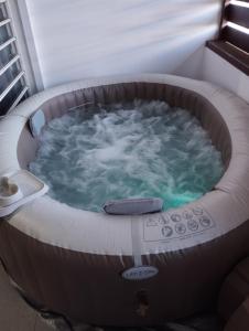 a jacuzzi tub in a room at Loveroom avec siège massant et spa in Cayenne