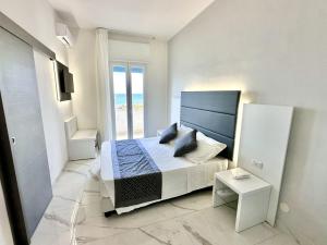 a bedroom with a bed and a view of the ocean at Hotel Blu in Porto Cesareo +58 photos