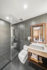 a bathroom with a toilet and a sink and a mirror at Palazzo 3 Danang Hotel in Da Nang