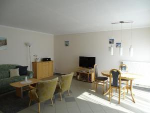 a living room with a couch and a table and chairs at Ferienwohnung 3 in Pudagla auf der Insel Usedom in Pudagla