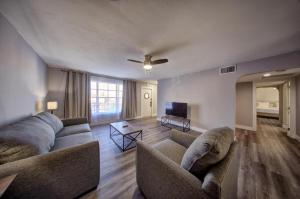 a living room with two couches and a ceiling fan at Mahalo Isles Apartments by Rocketstay in Fort Lauderdale