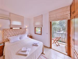 a bedroom with a bed and a balcony at Villa Sarpedon in Kaş +14 photos