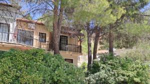 an apartment building with a balcony and trees at Calming Mountain View Apt with Balcony & Free Parking near Kakopetria in Nicosia