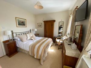 a bedroom with a bed and a television in it at The Mill in Dunfanaghy