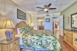 a bedroom with a bed and a ceiling fan at Villa Madeira 404 - Premier in St. Pete Beach +47 photos