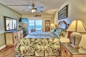 a bedroom with a bed and a ceiling fan at Villa Madeira 404 - Premier in St. Pete Beach