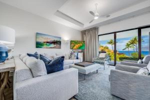 a living room with two couches and a table at MAKENA SURF #C102 condo in Wailea