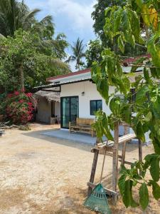 una casa con un rastrello verde davanti di Sunset Serenity Retreat a Ko Phangan