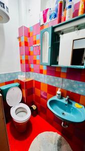 a colorful bathroom with a toilet and a sink at Hostel Balkan Han in Sarajevo