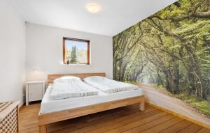 a bedroom with a large painting on the wall at 2 Bedroom Lovely Home In Ebeltoft in Ebeltoft