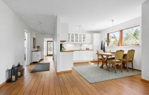 a kitchen and dining room with a table and chairs at 2 Bedroom Lovely Home In Ebeltoft in Ebeltoft