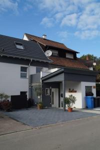 a house with a parking lot in front of it at Ferienwohnung Sigwart in Efringen-Kirchen