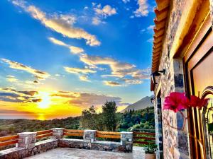 een raam van een huis met uitzicht op de zonsondergang bij Cassiopea Guest House Evia Greece in Nerotriviá