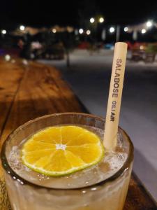 una bebida con una rodaja de naranja en una mesa en Salabose Cottages, en Gili Air