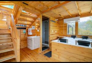 a log cabin kitchen with a sink and a window at Ecocabaña con Jacuzzi Ecocabañas ByB in Choachí