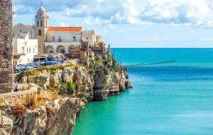 a group of buildings on a cliff next to the ocean at 1 Bedroom Gorgeous Apartment In Vieste in Vieste