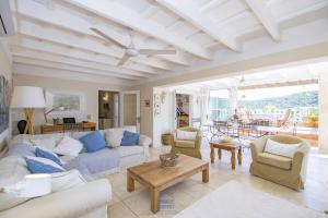 - un salon avec un canapé, des chaises et une table dans l'établissement Lovely family villa sleeps 8, with stunning views, à Port Mahon