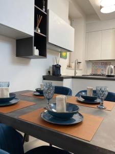 a kitchen with a table with plates and glasses on it at Daffy House in Desenzano del Garda