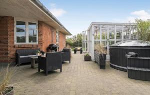 un patio con vasca idromassaggio e una serra di 5 Bedroom Cozy Home In Thyborn a Thyborøn
