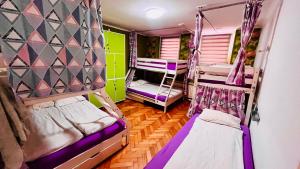 a room with three bunk beds in a room at Hostel Balkan Han in Sarajevo