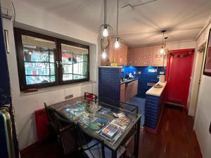 a kitchen with a table and chairs in a room at Hostel Balkan Han in Sarajevo