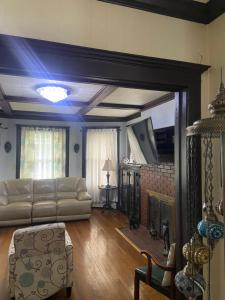 a living room with a couch and a fireplace at Elizabeth New Jersey bedroom -Newark Airport -New York City in Elizabeth