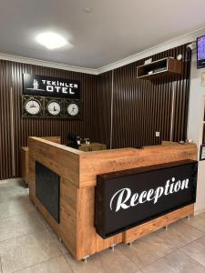 a reception desk in a store with a sign on the wall at TEKİNLER OTEL in Balıkesir